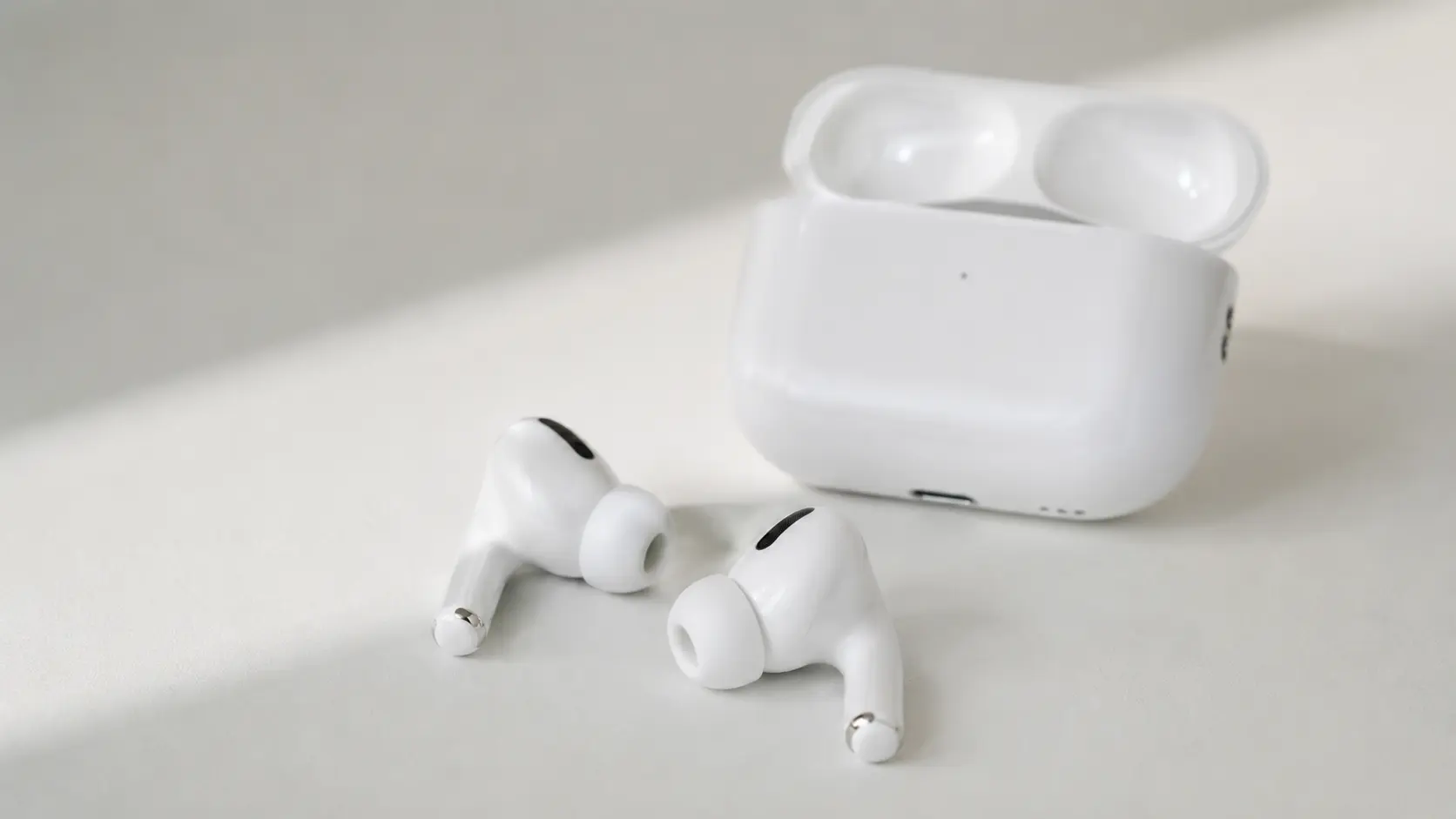 Apple AirPods Pro 2 with USB-C charging case placed on a white surface in 2026